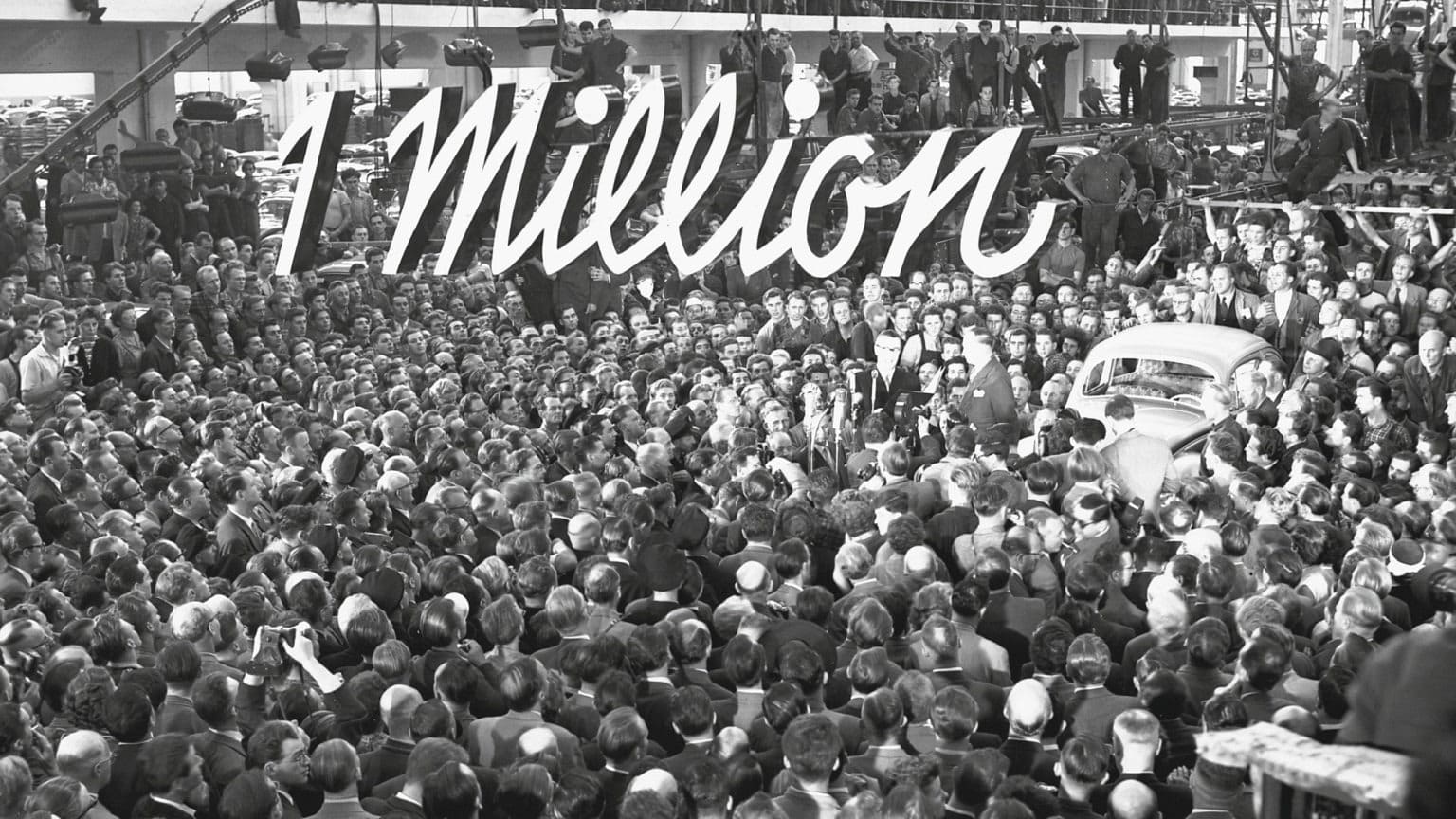 A large crowd celebrates the one millionth VW Bettle.