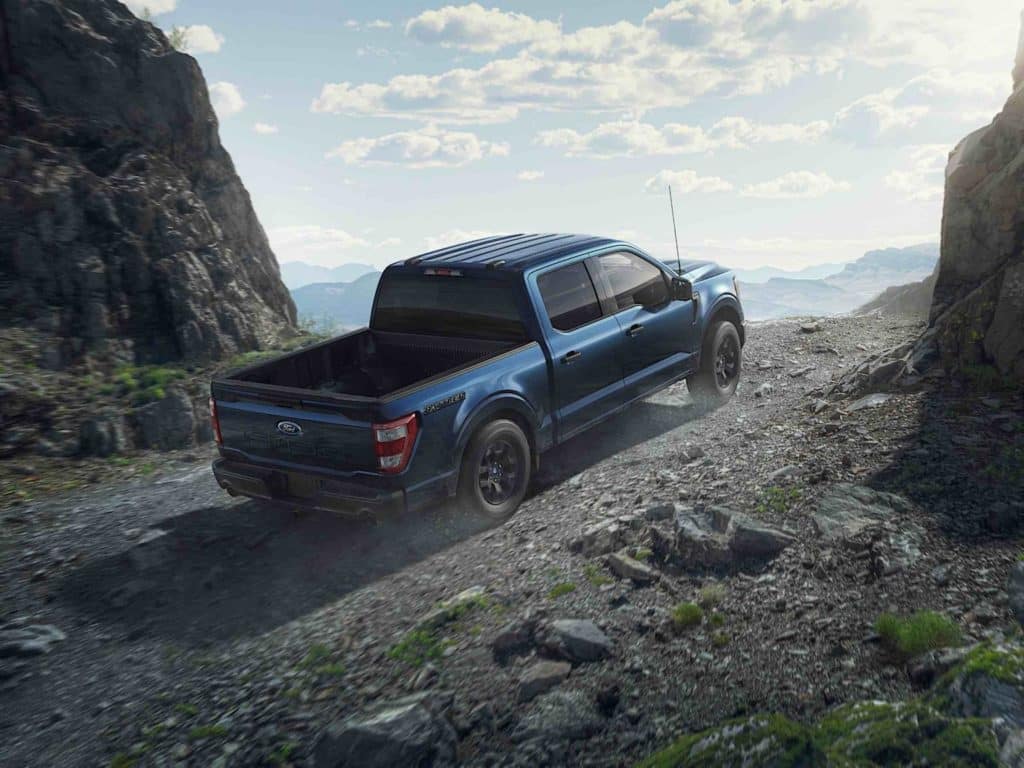 Ford F-150 Rattler driving across dirt and rock roads.