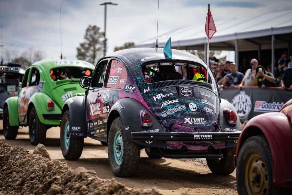 A VW Bettle racing on a dirt track.