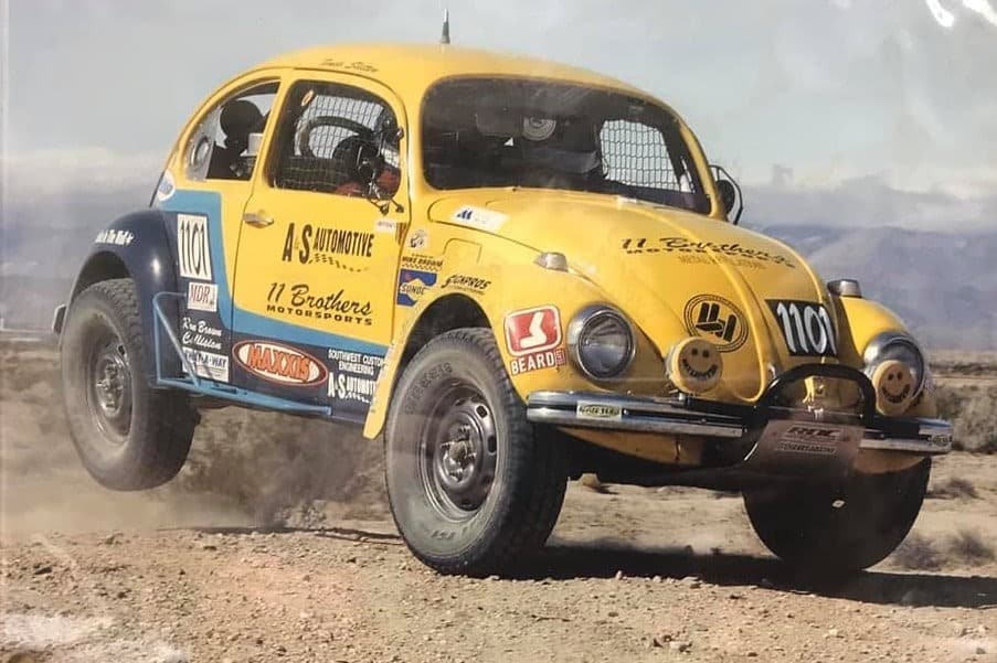 VW Bettle racing on a dirt track.