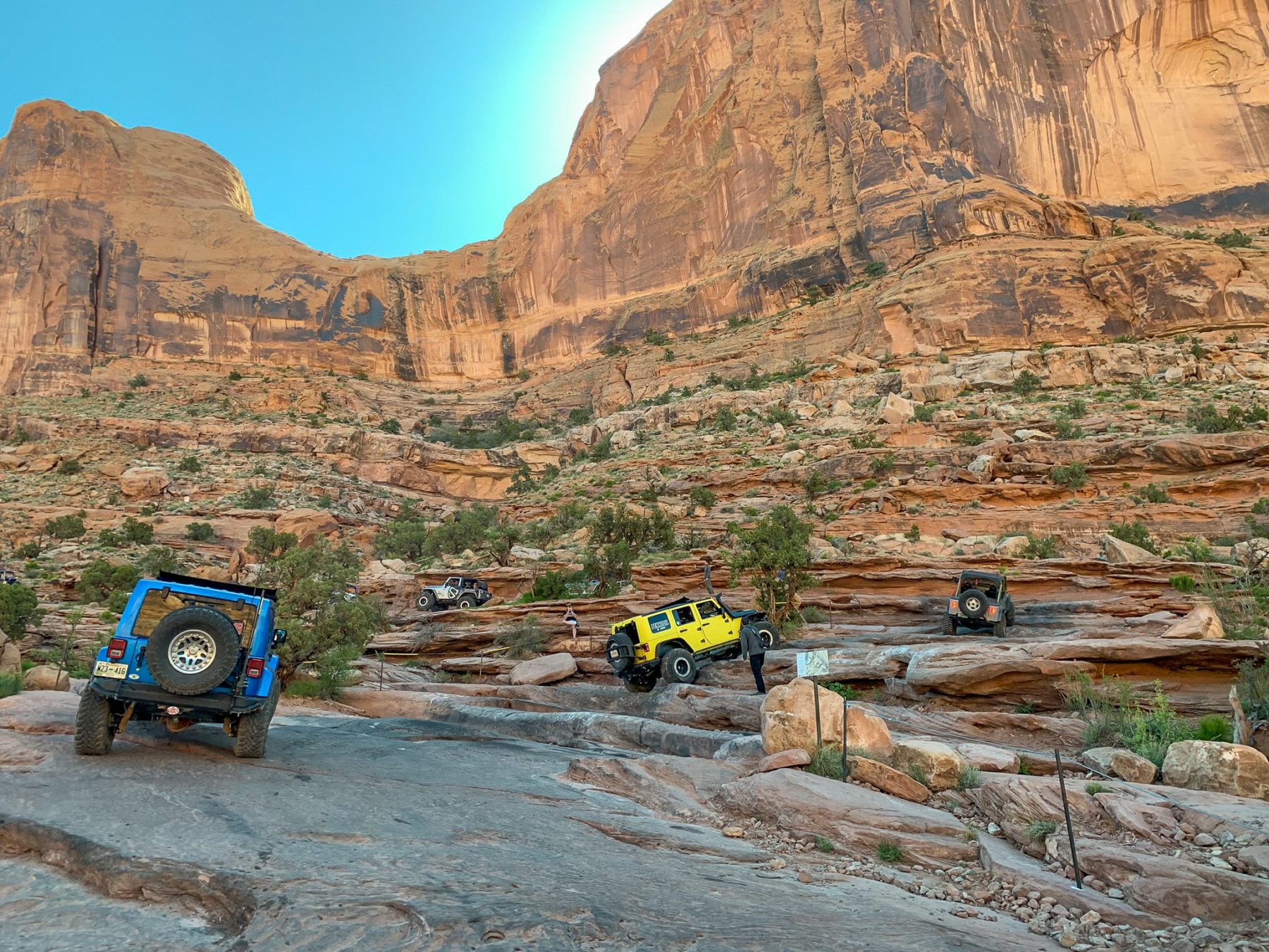 A yellow Jeep rides along an off-road track near the Grand Canyon.