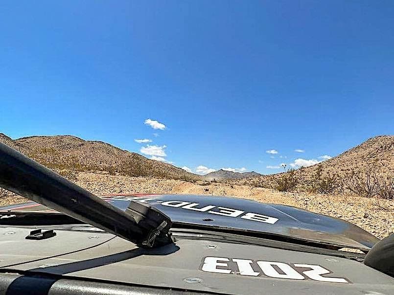 View of the desert from the cab of a racing truck.