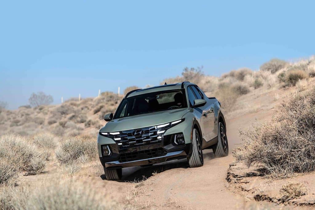 A Hyundai Santa Cruz driving through the desert.