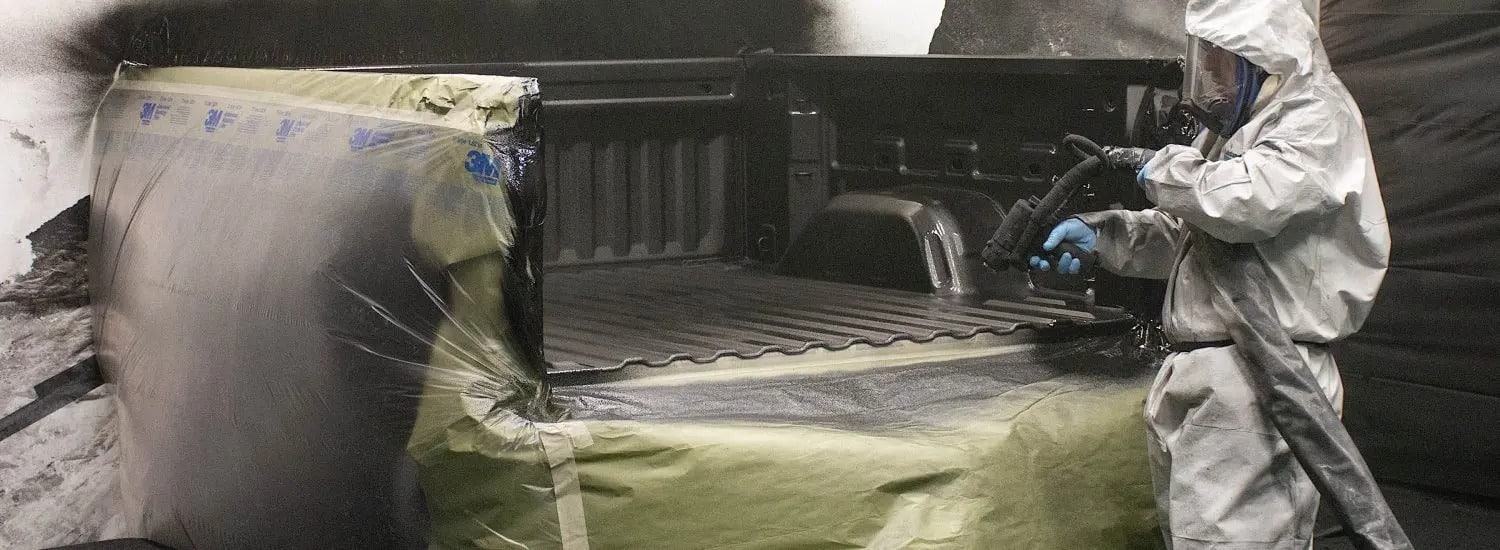 A truck bed being coated with A Line-X Bedliner.