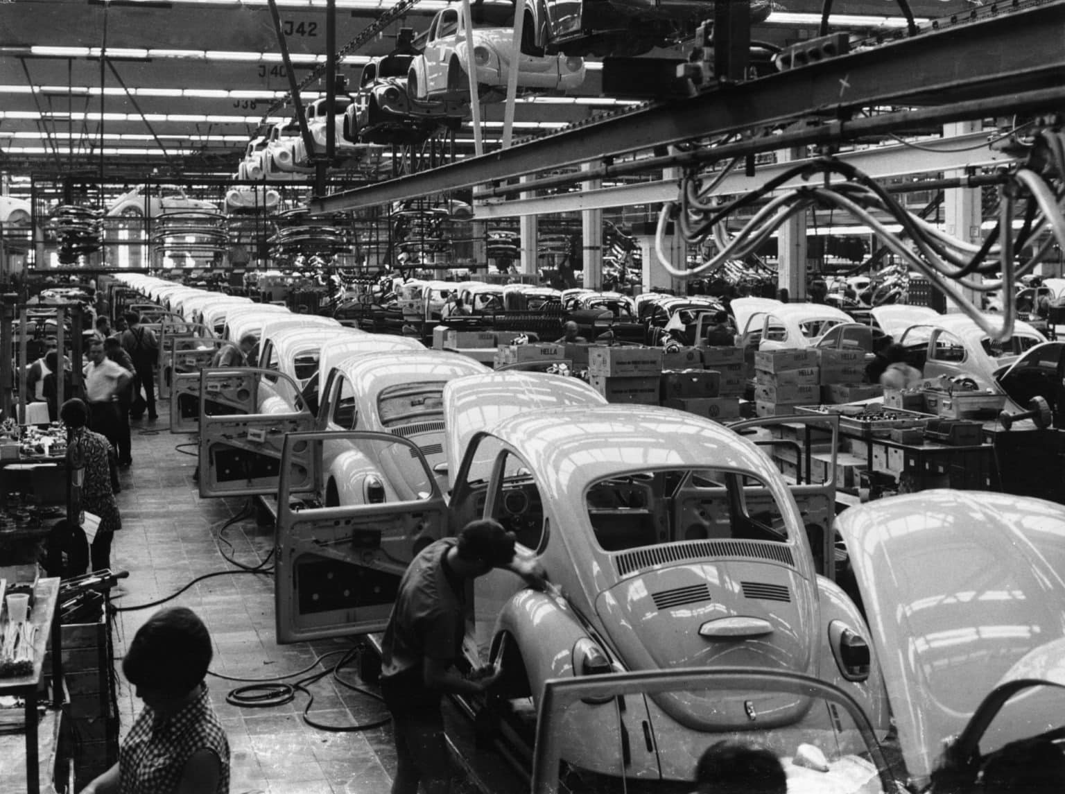 A black and white image of a VW Bettle production line.