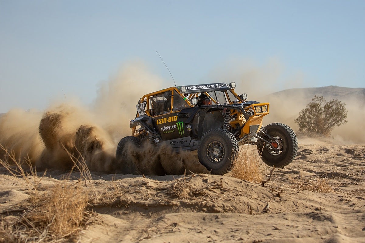 A sport utv racing across the sands.