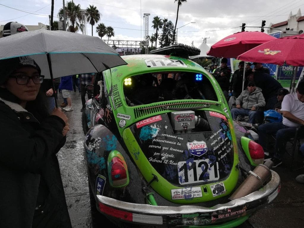 A VW Bettle racing on a dirt track.