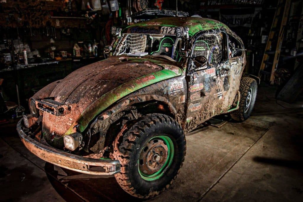 A VW Bettle racing on a dirt track.