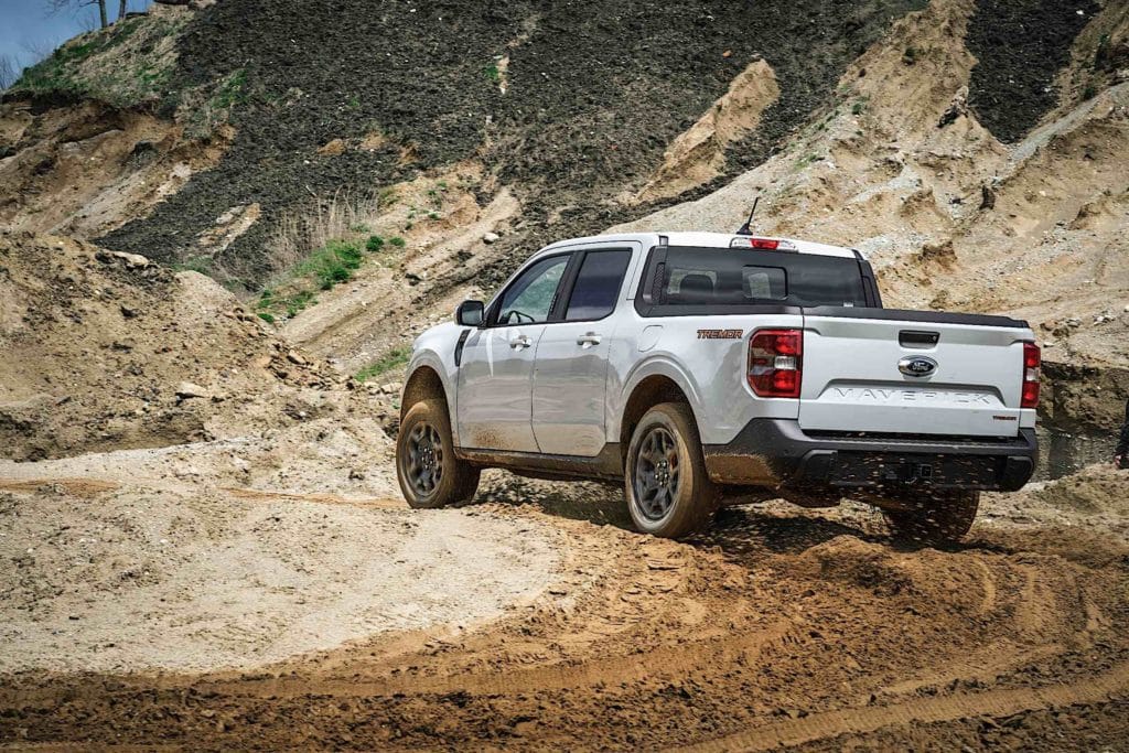 A 2023 Ford Maverick truck cutting circles in the mud and dirt.