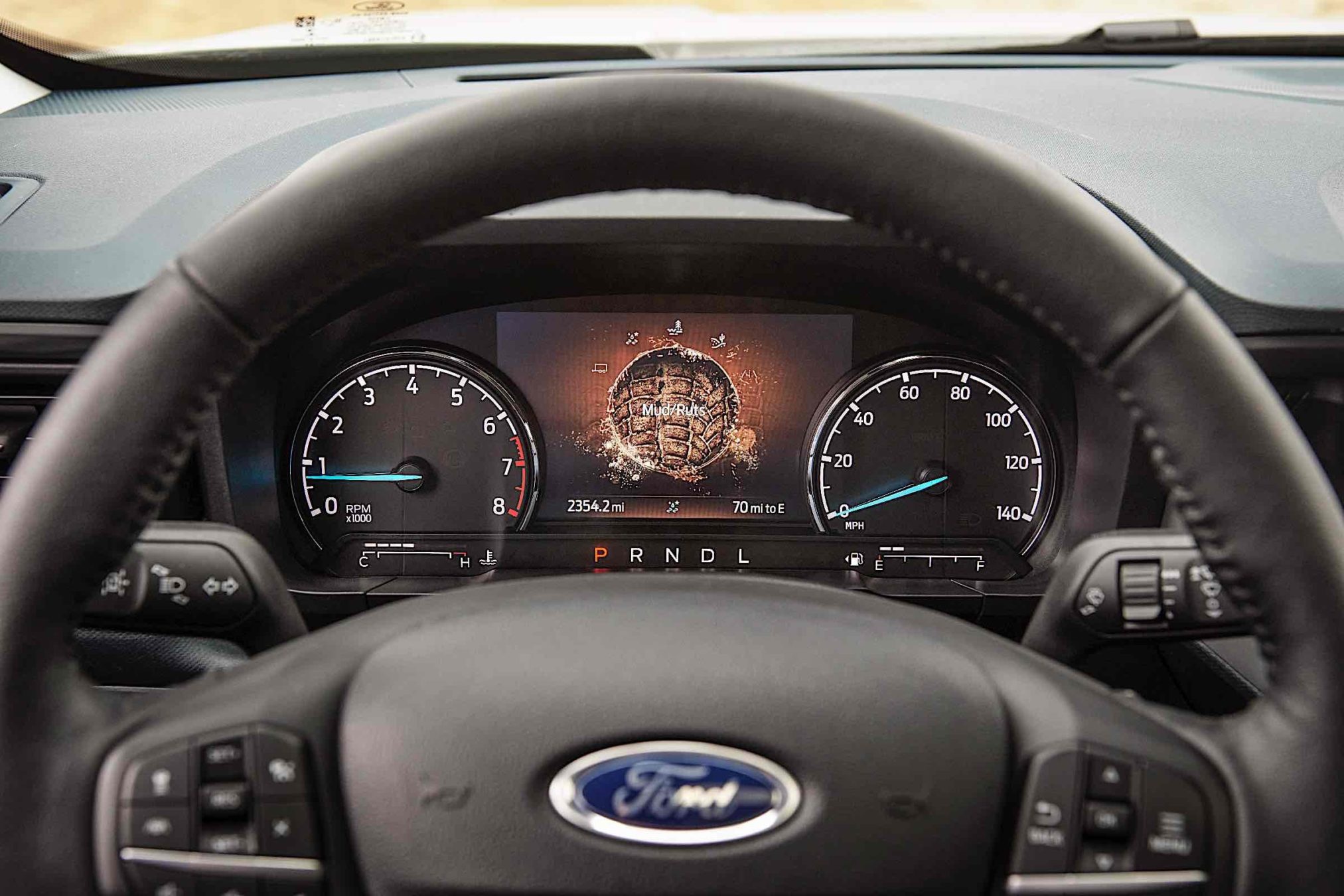 The dashboard display of a 2023 Ford Maverick truck showing mud/rut terrain enabled.