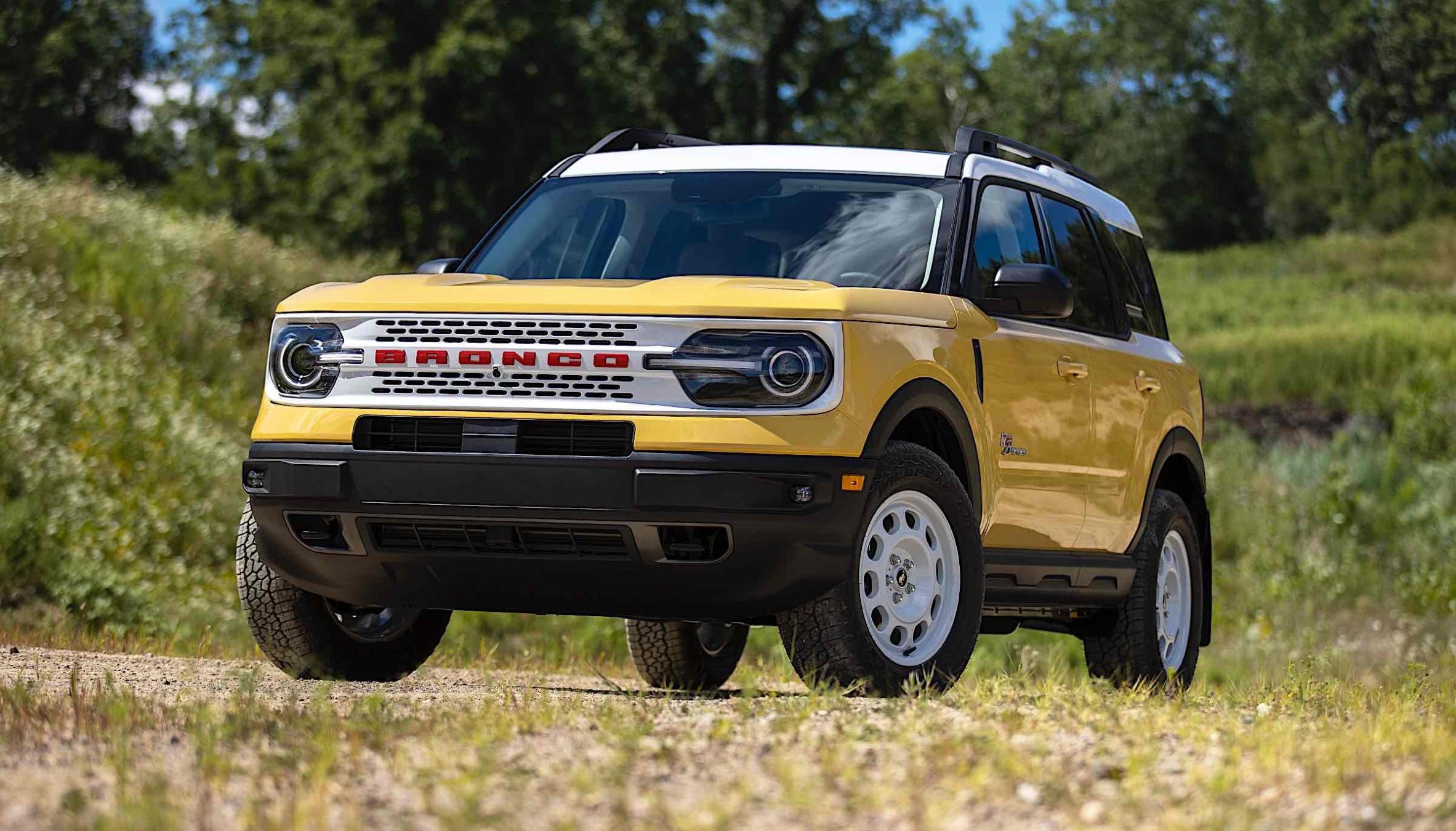 A yellow 2023 Ford Bronco in the wilderness.