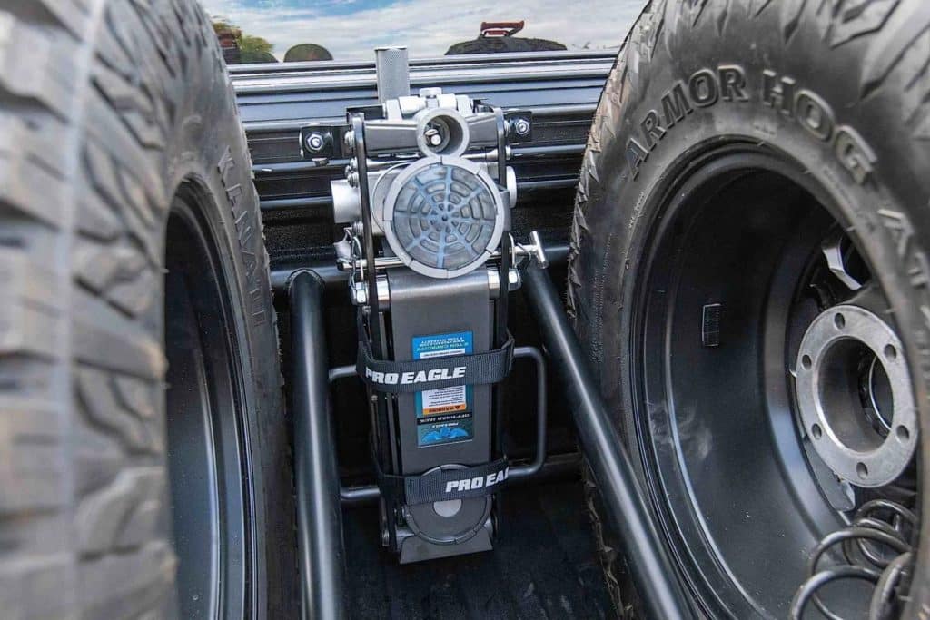 A tire jack mounted on a tire rack.