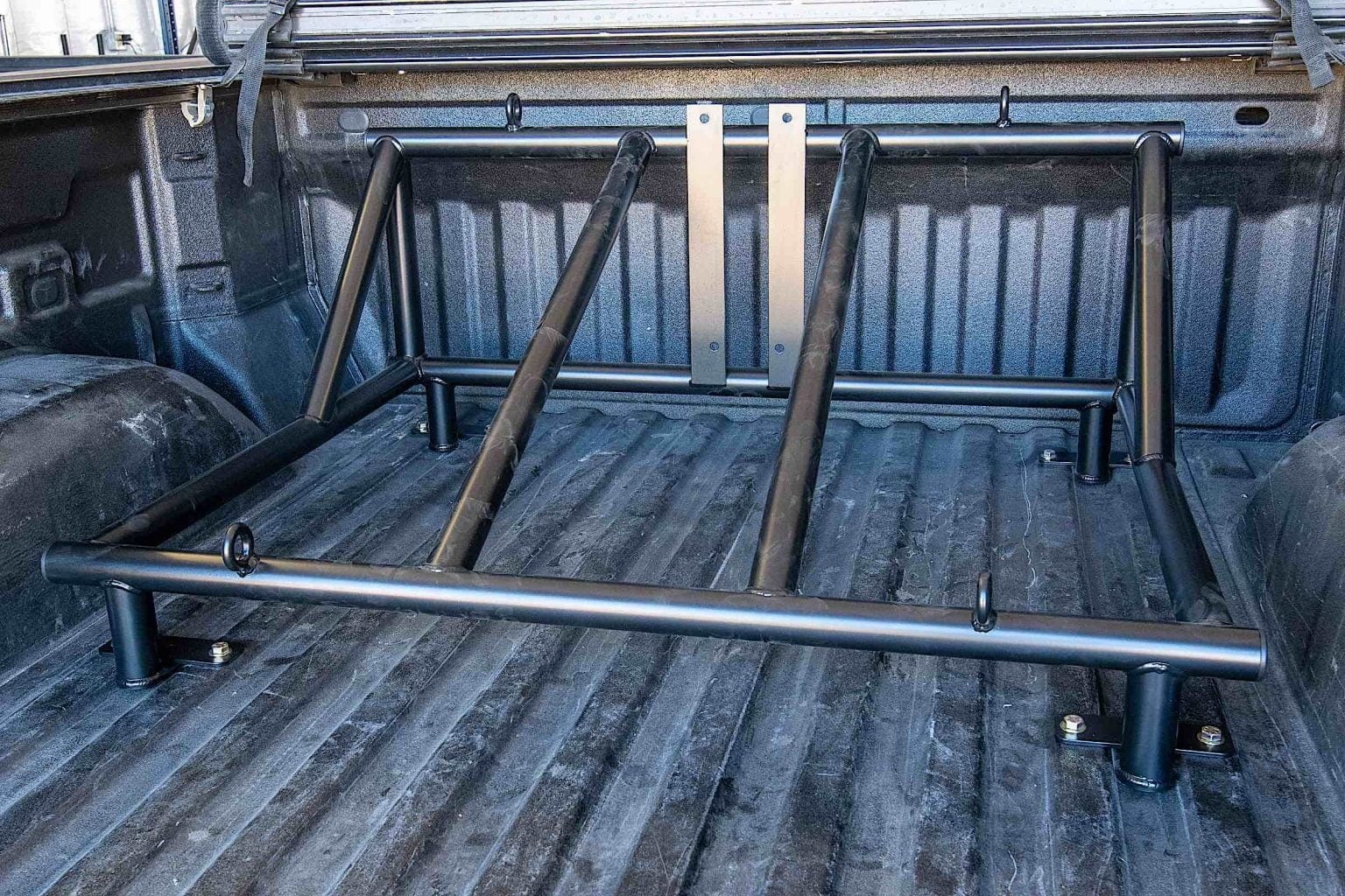 Installing a tire rack into a truck bed.