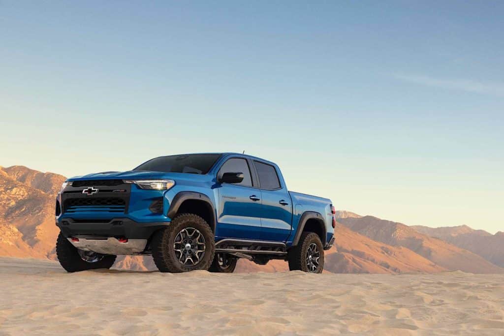 A 2023 Chevrolet Colorado driving down a dirty and rocky terrain.