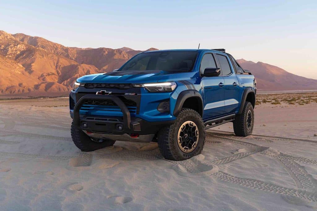 A 2023 Chevrolet Colorado driving down a dirty and rocky terrain.