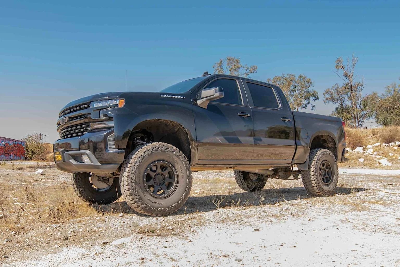 A 2019 Chevrolet Silverado on a dirt and rocky terrain.