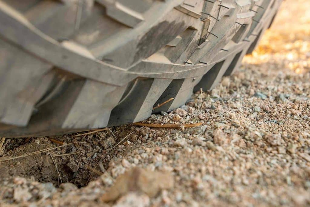 Close up detail of Mickey Thompson Baja Boss tire treads in the dirt.