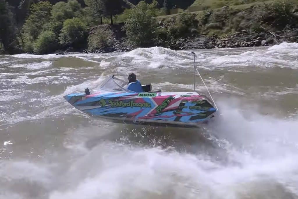 Three mini-boats riding down a river.